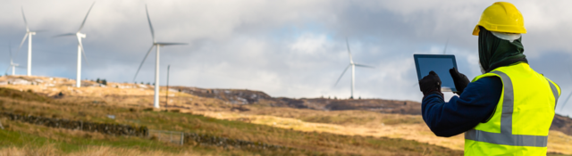 Employee testing wind turbine using device