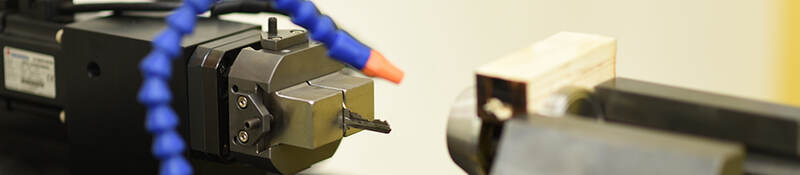 A lock cylinder being cycled to determine durability of the mechanism