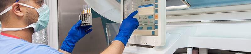 Male nurse checking medical device