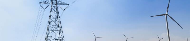 GettyImages-1041657420-solar-panels-wind-turbine-HEADER-2400x1600