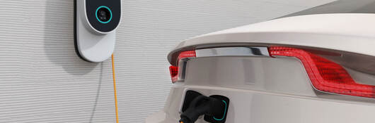 An electric vehicle plugged into a charging station