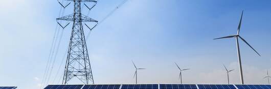 GettyImages-1041657420-solar-panels-wind-turbine-HEADER-2400x1600