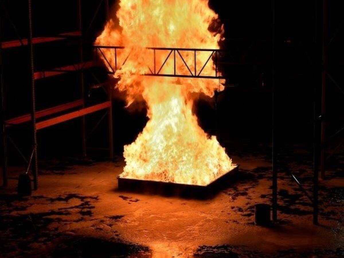 A large fire being evaluated in a fire testing lab. 