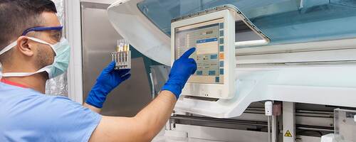 Male nurse checking medical device